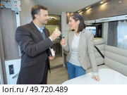Lady accepting keys for campervan. Стоковое фото, агентство Ingram Publishing / Фотобанк Лори