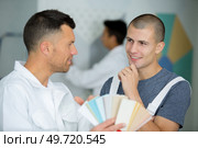 professional painters choosing from a set of color swatches. Стоковое фото, агентство Ingram Publishing / Фотобанк Лори
