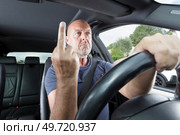 man shows an indecent gesture with his finger. Стоковое фото, агентство Ingram Publishing / Фотобанк Лори