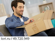 man open the box and feel excited. Стоковое фото, агентство Ingram Publishing / Фотобанк Лори