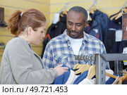 man and woman are deciding in uniform store. Стоковое фото, агентство Ingram Publishing / Фотобанк Лори
