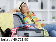 woman daydreaming beside her bag. Стоковое фото, агентство Ingram Publishing / Фотобанк Лори