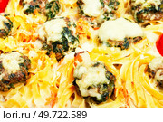 Delicious nests of Fettuccine pasta with meatballs and nettles. Casserole. Close up. Nest of noodle with meatballs. Стоковое фото, агентство Ingram Publishing / Фотобанк Лори