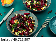 Diet salad of boiled beets, nuts and cheese on the plate. Beet or beetroot salad.. Vegetable salad with beets and nuts. Стоковое фото, агентство Ingram Publishing / Фотобанк Лори