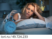 troubled insomniac woman in bed near an alarm clock. Стоковое фото, агентство Ingram Publishing / Фотобанк Лори