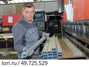 portrait of a man and metal frame support. Стоковое фото, агентство Ingram Publishing / Фотобанк Лори
