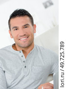 portrait of handsome young man smiling at home. Стоковое фото, агентство Ingram Publishing / Фотобанк Лори