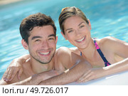 Portrait of attractive couple in pool. Стоковое фото, агентство Ingram Publishing / Фотобанк Лори