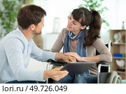 happy loving bearded man and disabled woman using a tablet. Стоковое фото, агентство Ingram Publishing / Фотобанк Лори