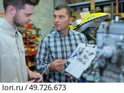 portrait of mechanical engineering checking drawing. Стоковое фото, агентство Ingram Publishing / Фотобанк Лори