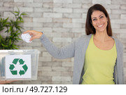 aware woman separating paper from other waste. Стоковое фото, агентство Ingram Publishing / Фотобанк Лори