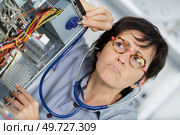 she is dealing with broken pc parts. Стоковое фото, агентство Ingram Publishing / Фотобанк Лори