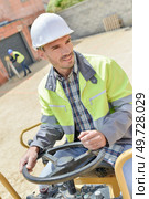 portrait of tractor operator at construction site. Стоковое фото, агентство Ingram Publishing / Фотобанк Лори