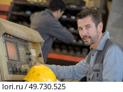 Portrait of man operating machine. Стоковое фото, агентство Ingram Publishing / Фотобанк Лори