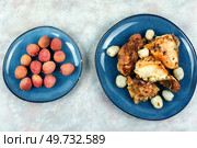 Pieces of grilled or smoked chicken thighs with lychee on a plate. Top view. A plate of chicken roasted with lychee. Стоковое фото, агентство Ingram Publishing / Фотобанк Лори