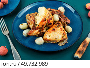Pieces of roasted chicken with lychee on a plate. Grilled poultry.. Baked chicken with lychee. Стоковое фото, агентство Ingram Publishing / Фотобанк Лори