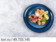 Appetizing tartlets or canapes with fish, shrimp and bacon. Flat lay with copy space.. Festive tartlets with fish, shrimp and bacon. Стоковое фото, агентство Ingram Publishing / Фотобанк Лори