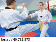 Fighting in a dojo. Стоковое фото, агентство Ingram Publishing / Фотобанк Лори