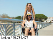 friend and woman in a wheelchair on a pier. Стоковое фото, агентство Ingram Publishing / Фотобанк Лори