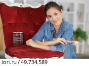 woman painting renewing chair at home. Стоковое фото, агентство Ingram Publishing / Фотобанк Лори