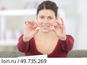 a woman holding two sim cards. Стоковое фото, агентство Ingram Publishing / Фотобанк Лори