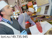 weighing an ordered meat. Стоковое фото, агентство Ingram Publishing / Фотобанк Лори
