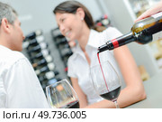 wine is being poured in a glass. Стоковое фото, агентство Ingram Publishing / Фотобанк Лори