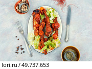 Piquant braised or stewed pork ribs in tomato sauce. Top view.. Delicious stewed pork ribs in sauce. Стоковое фото, агентство Ingram Publishing / Фотобанк Лори