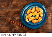 Roasted rolled potato shrimps, prawns and potato rolls. Space for text. Asian food.. Rolled potato shrimps, Vietnamese cuisine. Стоковое фото, агентство Ingram Publishing / Фотобанк Лори