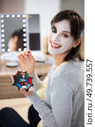 smiling woman applying halloween make-up. Стоковое фото, агентство Ingram Publishing / Фотобанк Лори