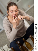 young woman in depression drinking alcohol and smokes cigarettes. Стоковое фото, агентство Ingram Publishing / Фотобанк Лори
