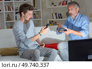 son and father and broken remote. Стоковое фото, агентство Ingram Publishing / Фотобанк Лори