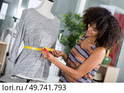 fashion designer preparing drafts for cut-outsor her new collection. Стоковое фото, агентство Ingram Publishing / Фотобанк Лори