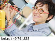 electrician specialist checking low-voltage pc. Стоковое фото, агентство Ingram Publishing / Фотобанк Лори