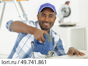 man cutting wood block with fretsaw. Стоковое фото, агентство Ingram Publishing / Фотобанк Лори