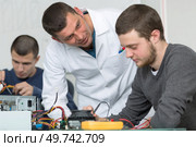 Teacher questioning reticent adolescent student. Стоковое фото, агентство Ingram Publishing / Фотобанк Лори