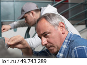 close-up apprentice holding a wrench. Стоковое фото, агентство Ingram Publishing / Фотобанк Лори