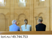 three people sat in church looking towards altar. Стоковое фото, агентство Ingram Publishing / Фотобанк Лори