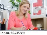 woman tailor working on a clothing sewing stitching measuring fa. Стоковое фото, агентство Ingram Publishing / Фотобанк Лори
