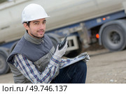 Man on construction site with walkie talkie. Стоковое фото, агентство Ingram Publishing / Фотобанк Лори