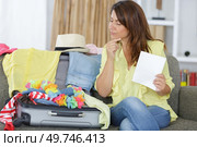 a woman packing before travelling. Стоковое фото, агентство Ingram Publishing / Фотобанк Лори