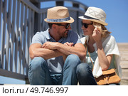 couple sat huddled together outdoors on a sunny day. Стоковое фото, агентство Ingram Publishing / Фотобанк Лори