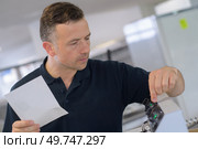 male technician working on a machine at the factory. Стоковое фото, агентство Ingram Publishing / Фотобанк Лори