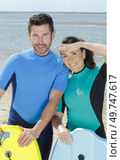 a happy couple before doing bodyboard. Стоковое фото, агентство Ingram Publishing / Фотобанк Лори