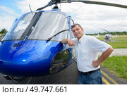 portrait of pilot standing in front of helicopter. Стоковое фото, агентство Ingram Publishing / Фотобанк Лори