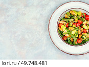 Plate with vitamin salad of mussels, arugula, tomato and avocado. Space for text.. Delicious seafood mussels salad. Стоковое фото, агентство Ingram Publishing / Фотобанк Лори