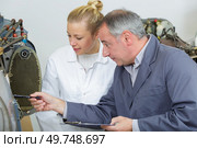 man and woman repairing an aircraft. Стоковое фото, агентство Ingram Publishing / Фотобанк Лори