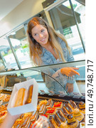 a woman and choice of pastry. Стоковое фото, агентство Ingram Publishing / Фотобанк Лори
