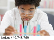 woman in the lab looking at pipettes. Стоковое фото, агентство Ingram Publishing / Фотобанк Лори