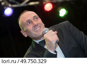 suited man performing on stage. Стоковое фото, агентство Ingram Publishing / Фотобанк Лори